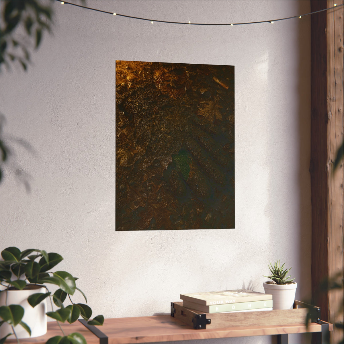Wet mud and pressed oak leaves with a green scrap barely showing. The Reliquary of Mud and Leaf by Garabaggio, fine art print hanging in a room.
