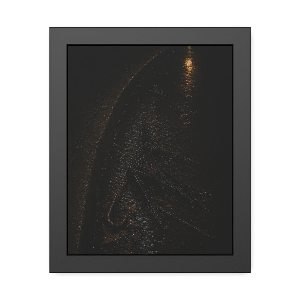 A collapsed umbrella in a dark wet gutter beside a curb, one distant light. The Procession in the Gutter by Garabaggio, framed fine art print, 11″ x 14″.