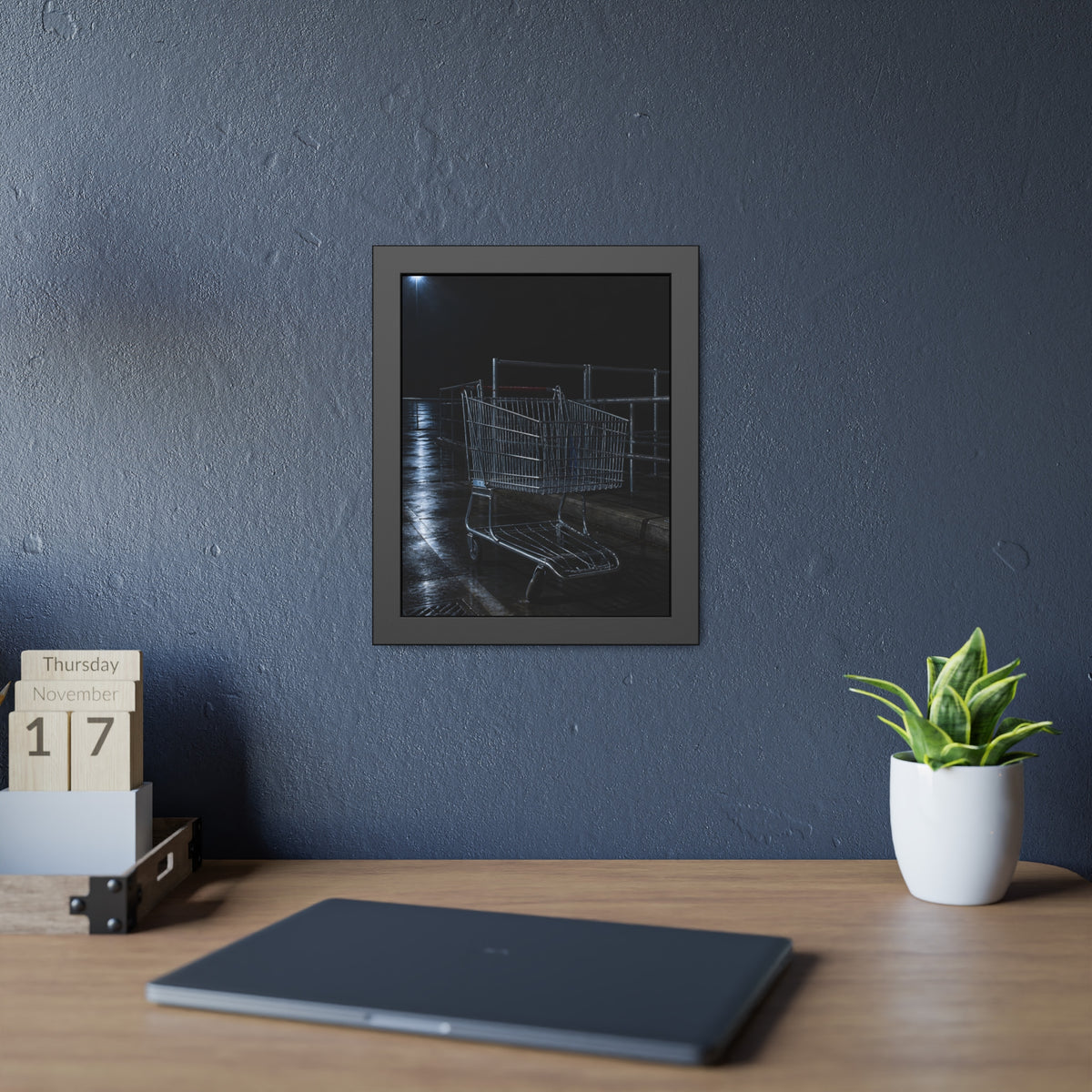A shopping cart beside its corral on wet asphalt under a lot light. The Cart at the Corral by Garabaggio, framed fine art print hanging in a room.
