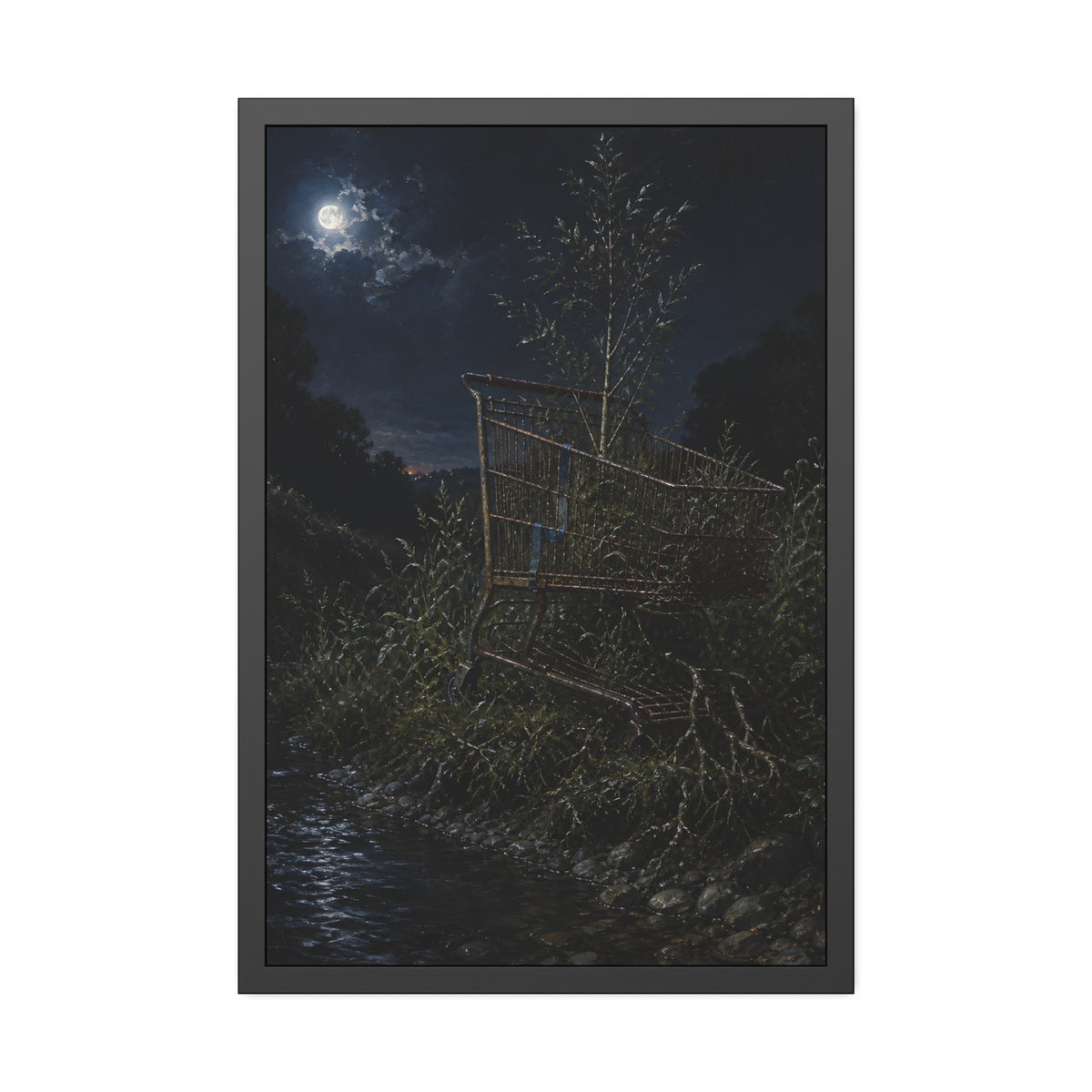 A shopping cart in creekside weeds with a sapling growing up through it. The Cart Grown Through by Garabaggio, framed fine art print, 24″ x 36″.