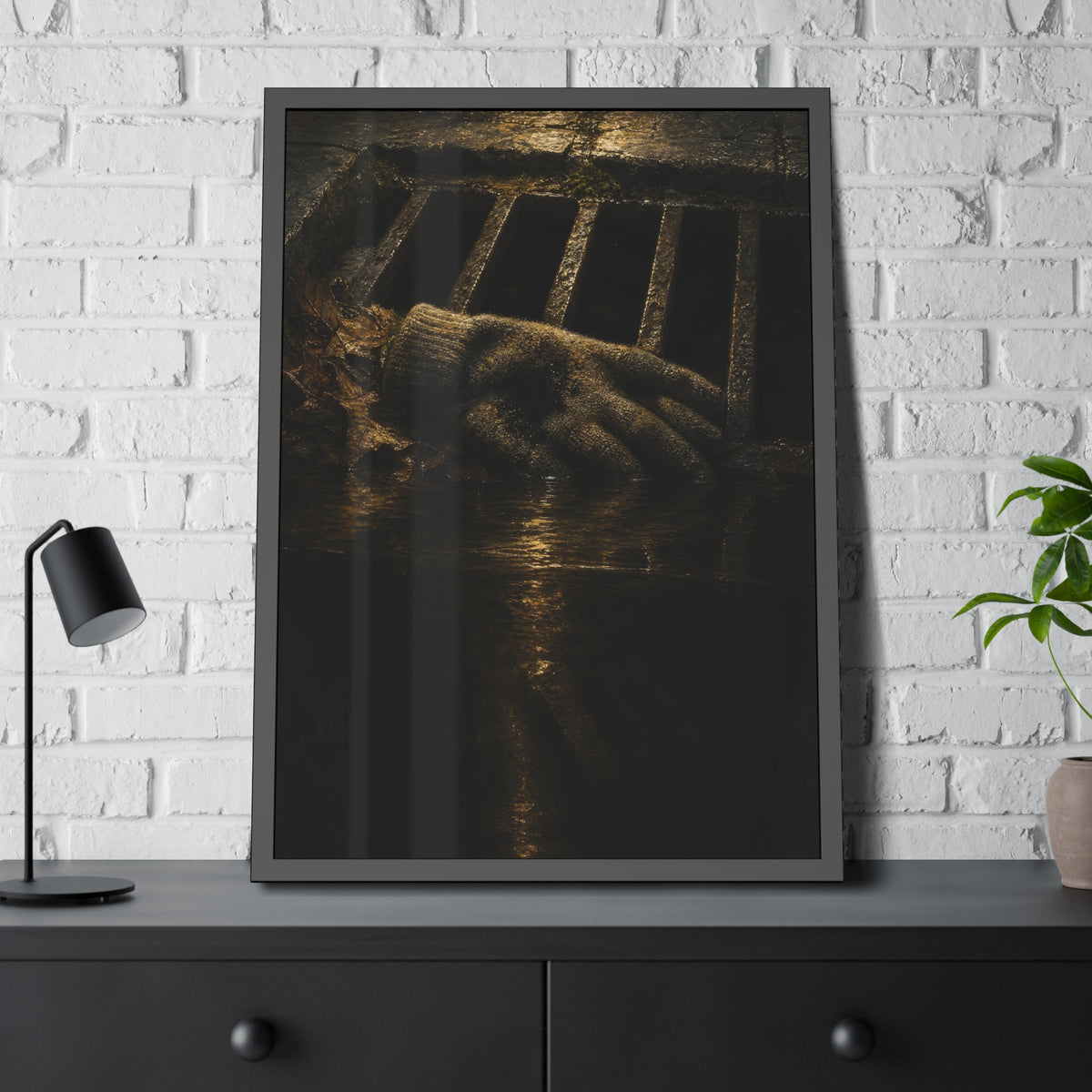 A single work glove on a storm drain grate above dark standing water. The Descent Into the Drain by Garabaggio, framed fine art print hanging in a room.