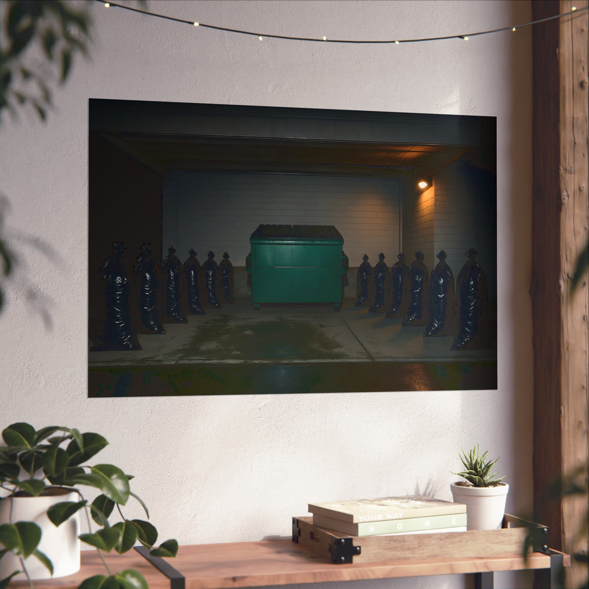 A green dumpster flanked by rows of black garbage bags under a lamp. Night Watch of the Loading Dock by Garabaggio, fine art print hanging in a room.
