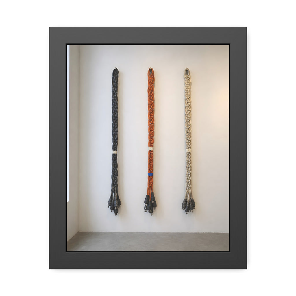 Three braided bundles of extension cords hung on a white gallery wall. The Braided Triptych by Garabaggio, framed fine art print, 11″ x 14″.