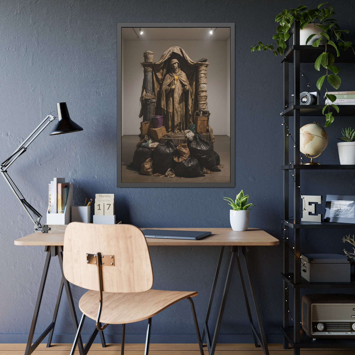 Draped standing figure under a canopy above a heap of black garbage bags. Saint Francis of the Black Bag by Garabaggio, framed fine art print hanging in a room.