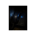 A grimy wall telephone in darkness with one small blue indicator light. The Night Queue by Garabaggio, fine art print, 12″ x 16″.