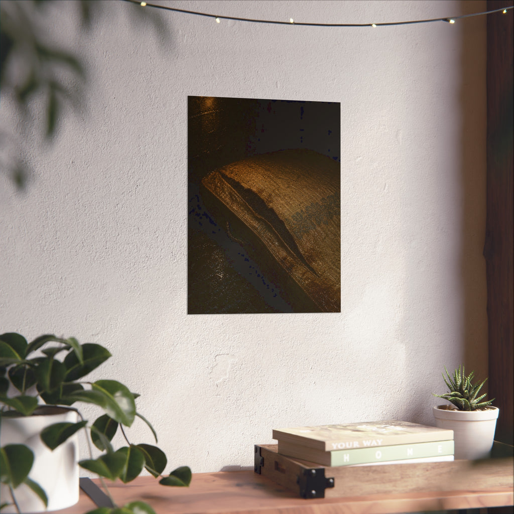 A mattress with its seam split open, lit warm against a dark wall. The Opening of the Ticking by Garabaggio, fine art print hanging in a room.