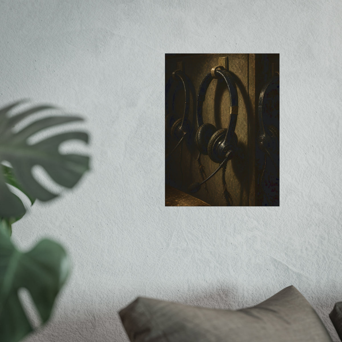 Three worn call center headsets hanging on wall hooks in dim light. The Headsets Left Hanging by Garabaggio, fine art print hanging in a room.