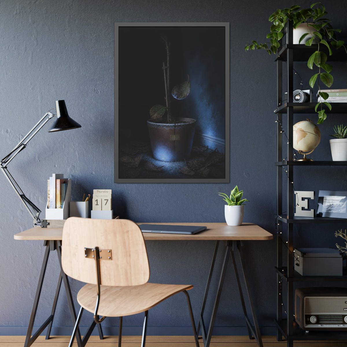 A bare potted plant dropping a leaf, dead leaves on the floor. The Leaf Lets Go by Garabaggio, framed fine art print hanging in a room.