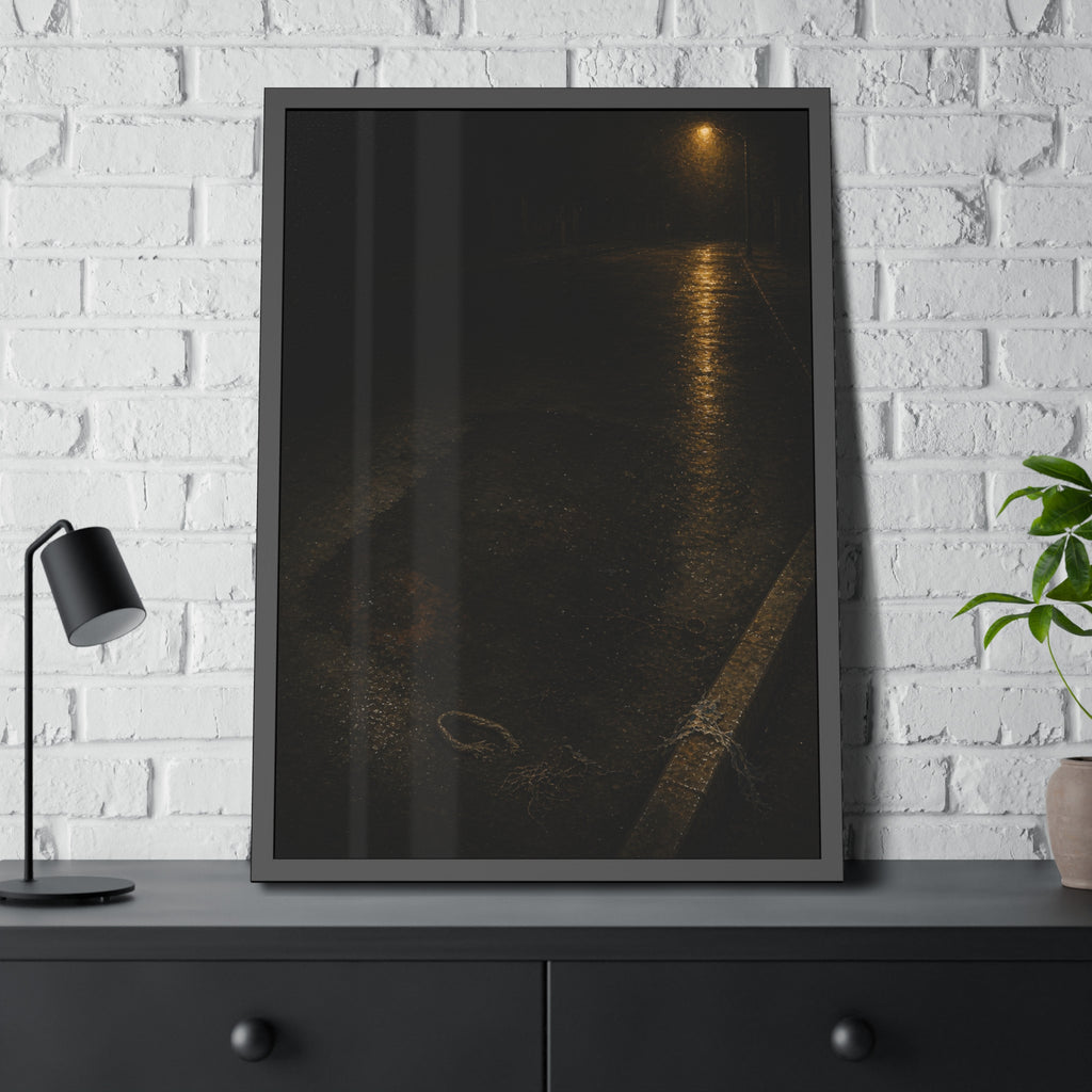 A rectangular stain on wet asphalt where something lay, under a streetlamp. The Stain After Removal by Garabaggio, framed fine art print hanging in a room.