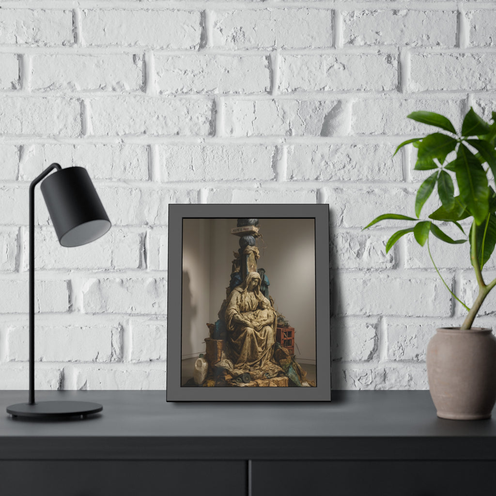 Seated hooded figure cradling a bundle on a mound of bagged refuse. Pietà of the Curbside by Garabaggio, framed fine art print hanging in a room.