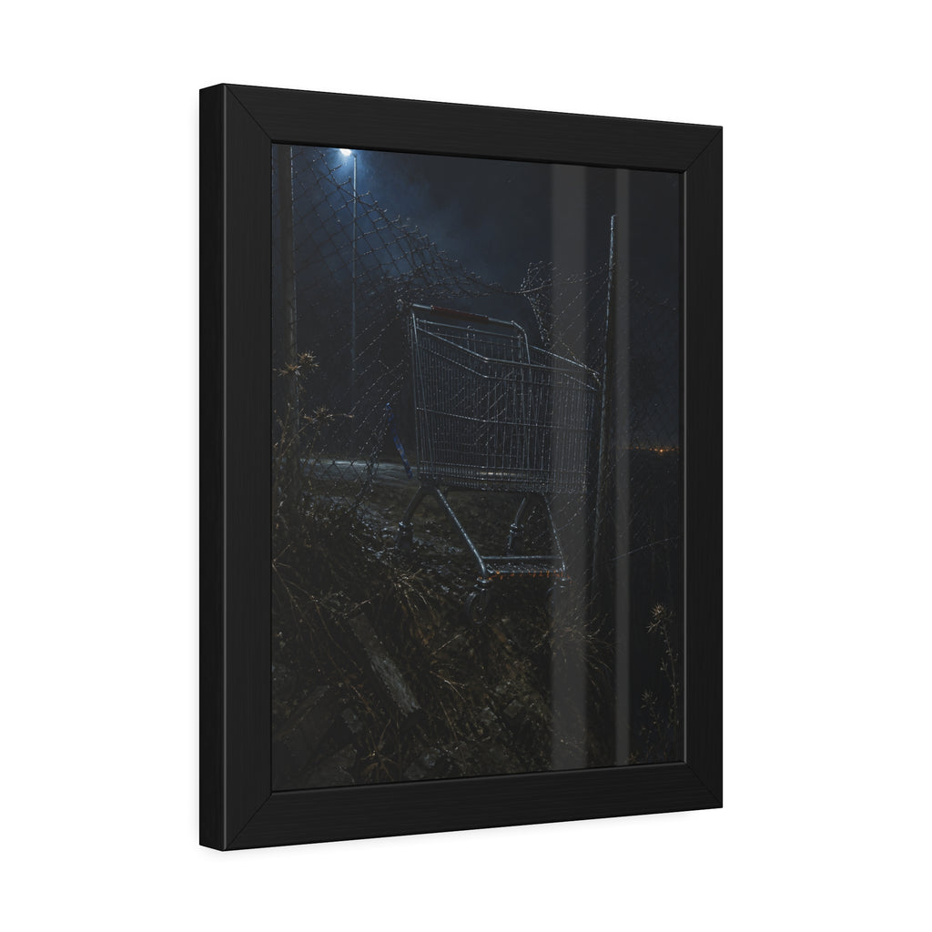 A shopping cart wedged in a chain link fence under a streetlamp. The Abandonment at the Ravine Fence by Garabaggio, framed fine art print hanging in a room.