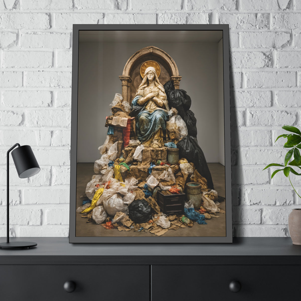 A robed statue on a mound of garbage bags in a gallery. The Immaculate Collection by Garabaggio, framed fine art print hanging in a room.
