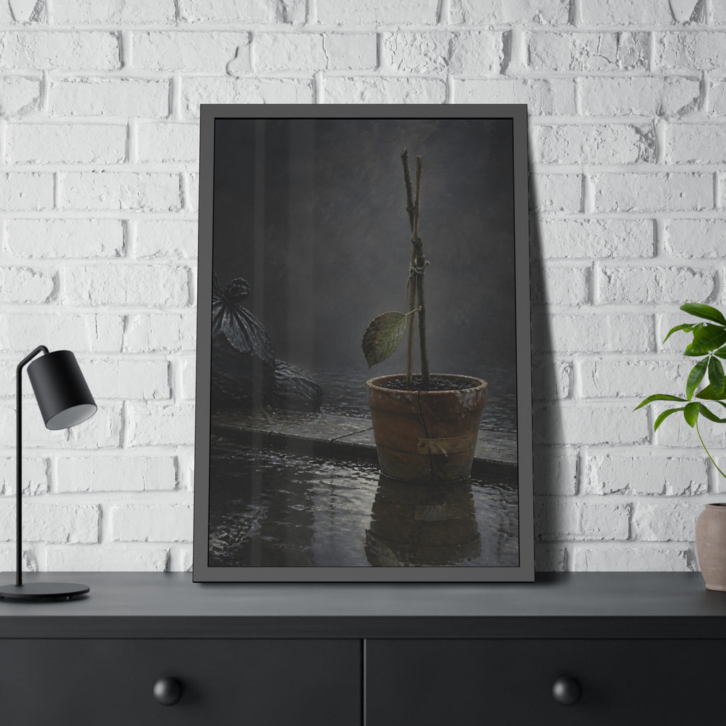 Bare tied stems in a clay pot on flooded pavement, one leaf remaining. The Grey Between by Garabaggio, framed fine art print hanging in a room.