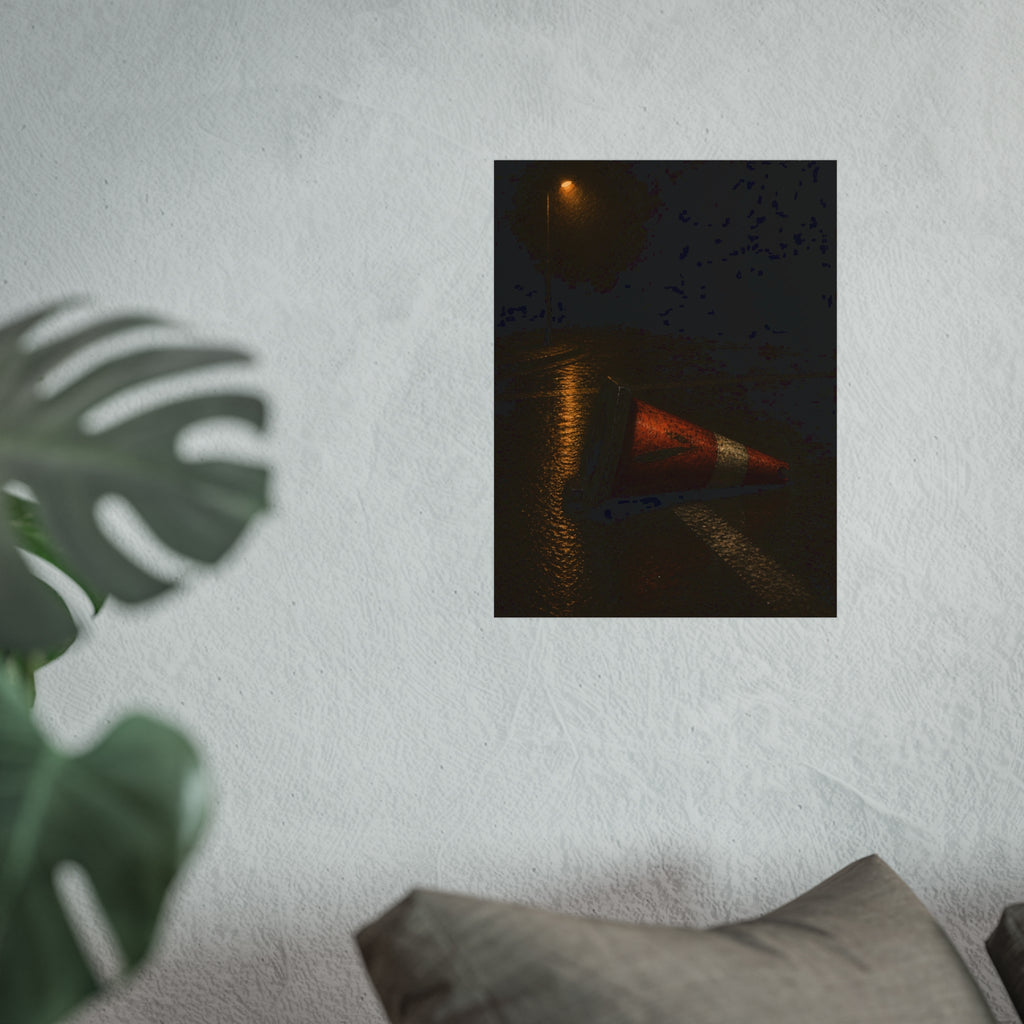 A toppled orange traffic cone on a wet road under a lone streetlight. The Taking by the Bumper by Garabaggio, fine art print hanging in a room.