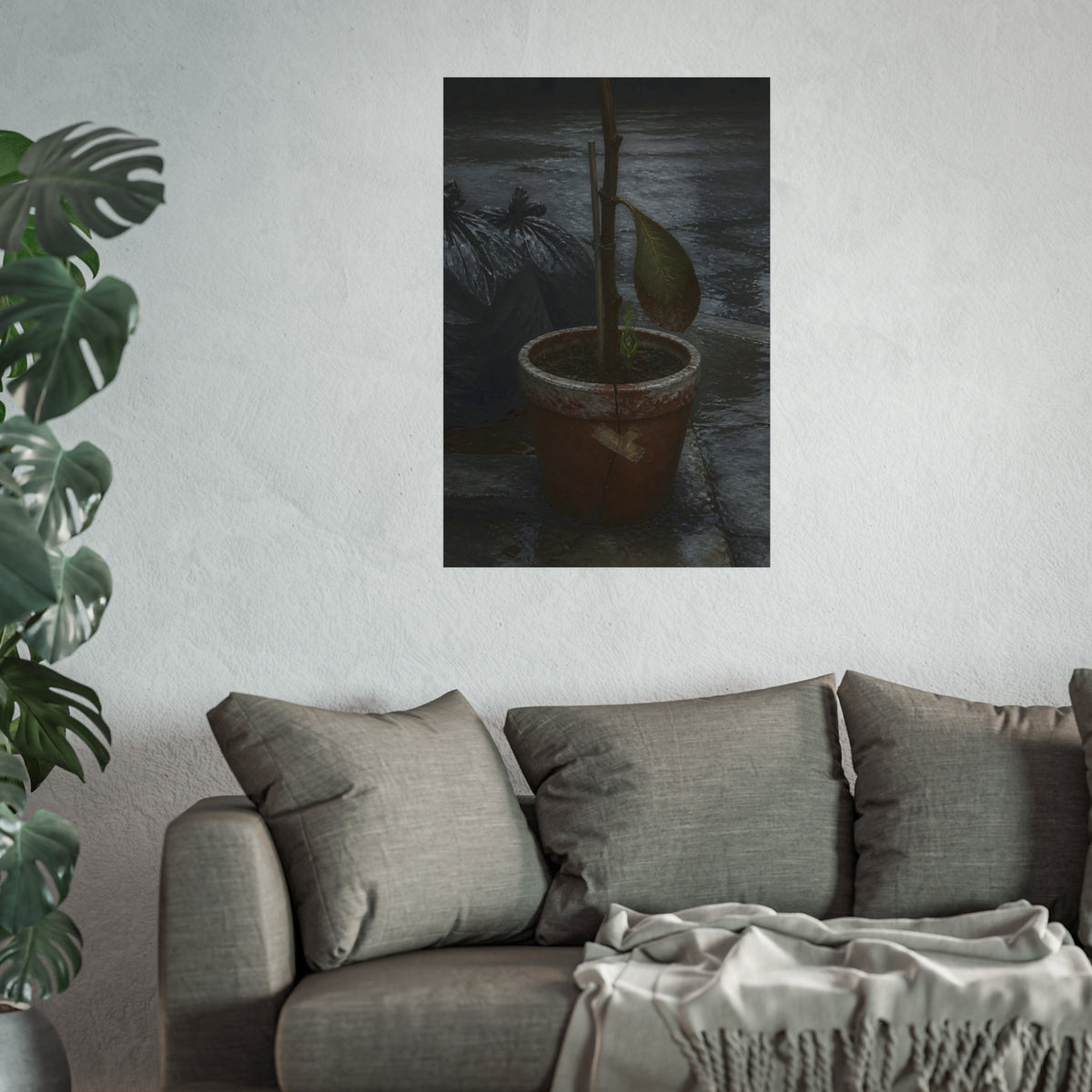A taped clay pot with one leaf and a green shoot on wet pavement. The Green at the Base by Garabaggio, fine art print hanging in a room.