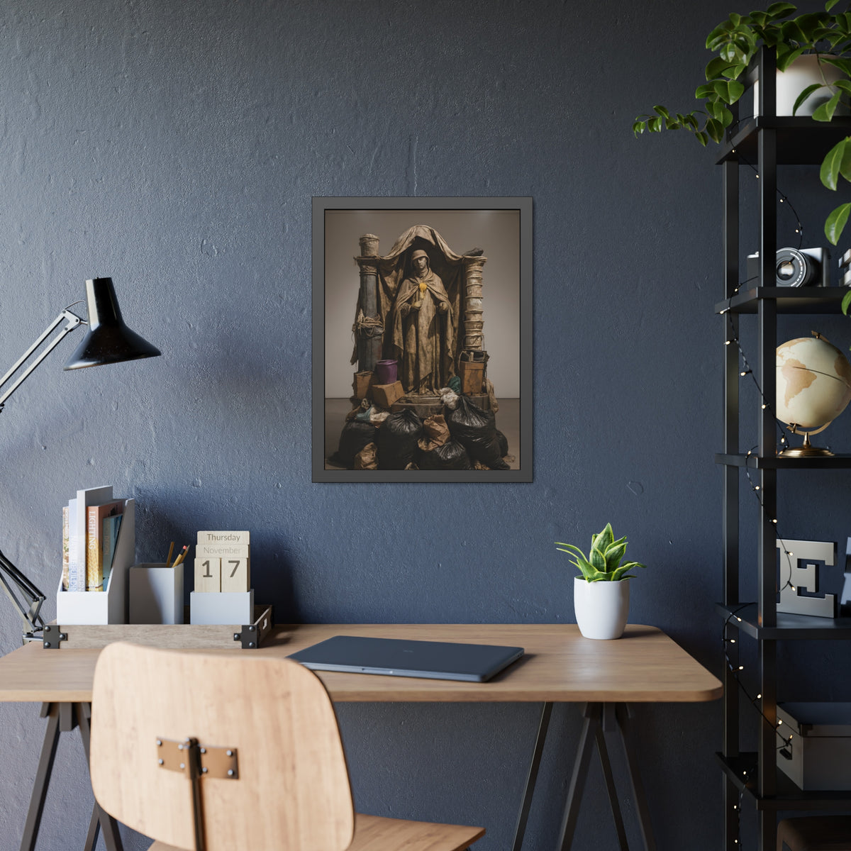 Draped standing figure under a canopy above a heap of black garbage bags. Saint Francis of the Black Bag by Garabaggio, framed fine art print hanging in a room.