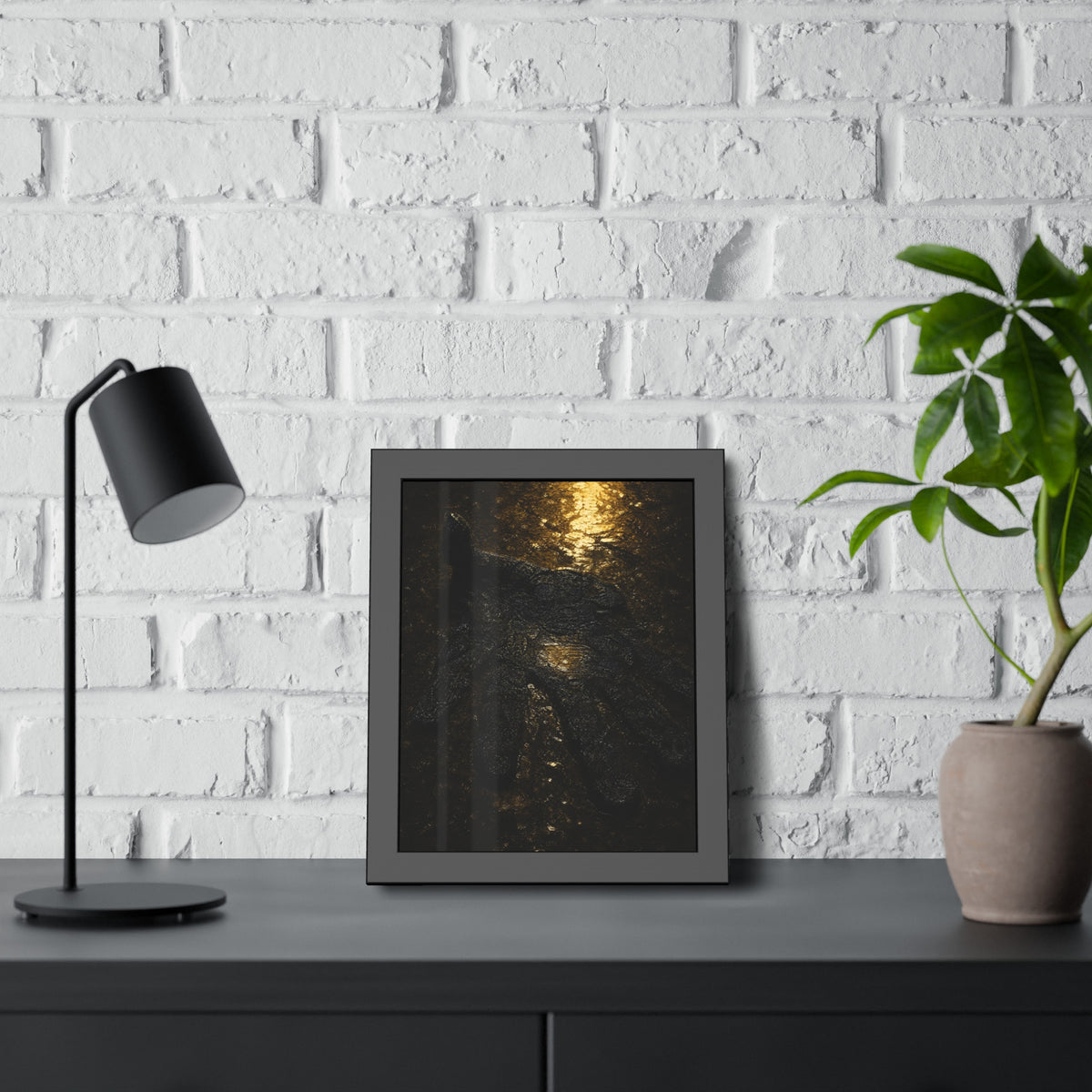 A flattened black glove pressed into wet asphalt beside a light streak. The Flattening, Study No. 1 by Garabaggio, framed fine art print hanging in a room.