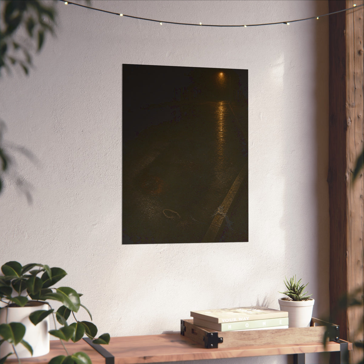 A rectangular stain on wet asphalt where something lay, under a streetlamp. The Stain After Removal by Garabaggio, fine art print hanging in a room.