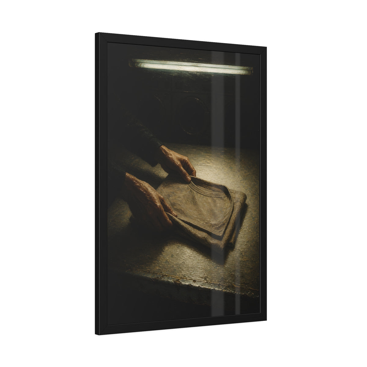 Two hands folding a shirt on a laundromat table with washers behind. The Folding at Two A.M by Garabaggio, framed fine art print hanging in a room.