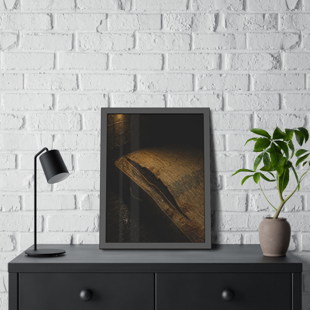 A mattress with its seam split open, lit warm against a dark wall. The Opening of the Ticking by Garabaggio, framed fine art print hanging in a room.