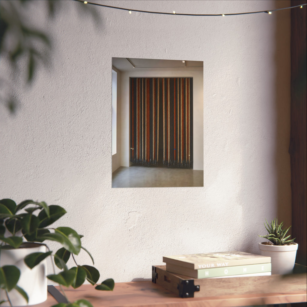 Hundreds of extension cords hung floor to ceiling across a bright white room. The Cord Curtain by Garabaggio, fine art print hanging in a room.