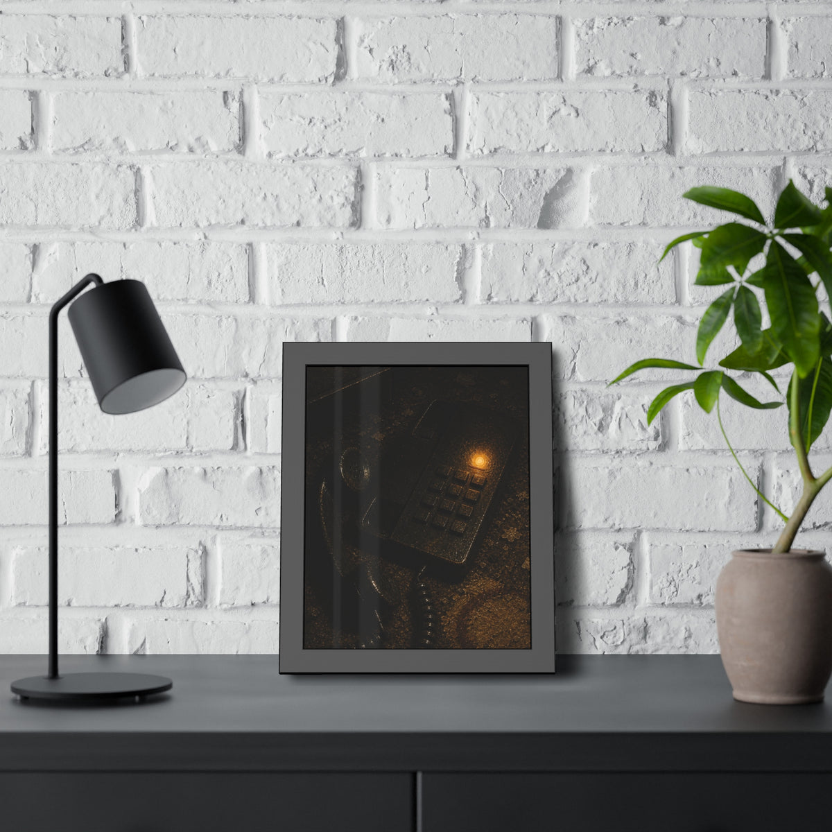A desk phone with the handset off the hook and one amber light glowing. The Line Still Rings by Garabaggio, framed fine art print hanging in a room.