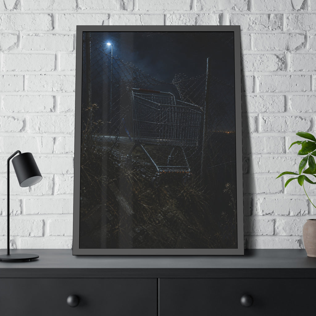 A shopping cart wedged in a chain link fence under a streetlamp. The Abandonment at the Ravine Fence by Garabaggio, framed fine art print hanging in a room.