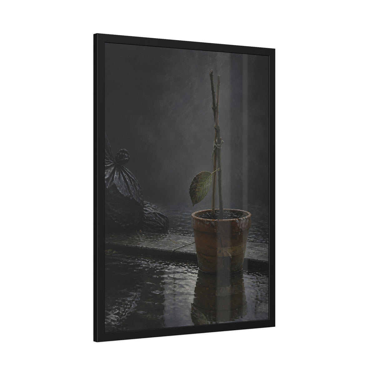Bare tied stems in a clay pot on flooded pavement, one leaf remaining. The Grey Between by Garabaggio, framed fine art print hanging in a room.