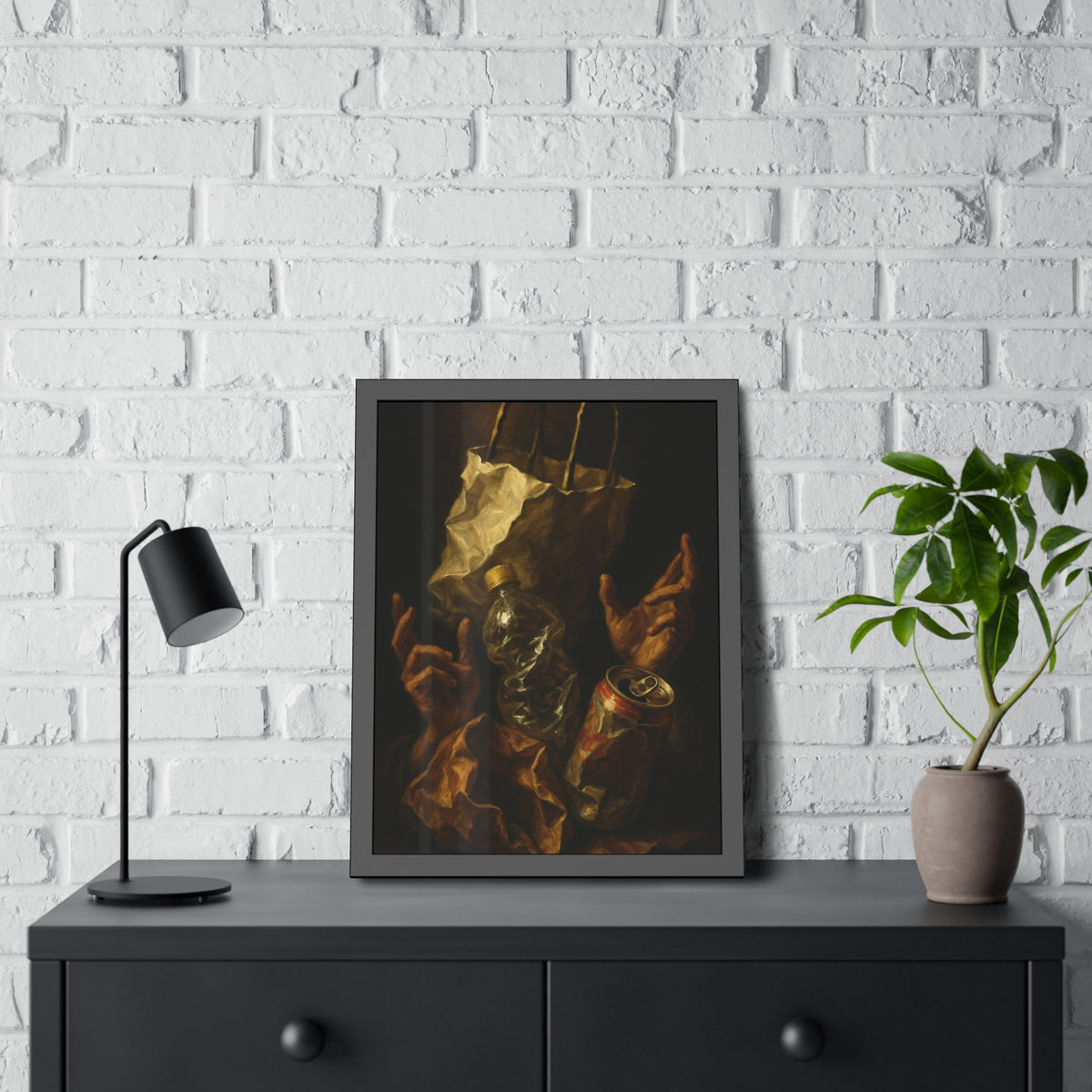 Two hands raised beside a paper bag, crushed bottle and dented can. The Assumption of the Discarded by Garabaggio, framed fine art print hanging in a room.