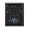 An empty swing set with frost on its crossbar under floodlights. Midnight: The Frost on the Crossbar by Garabaggio, framed fine art print, 11″ x 14″.