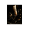Charred curls of paper heaped together, one pale roll standing upright. The Blackening by Garabaggio, fine art print, 12″ x 16″.