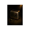 A scorched toaster on a dark counter with crumbs and its plug beside it. Shell Without Heat by Garabaggio, fine art print, 12″ x 16″.
