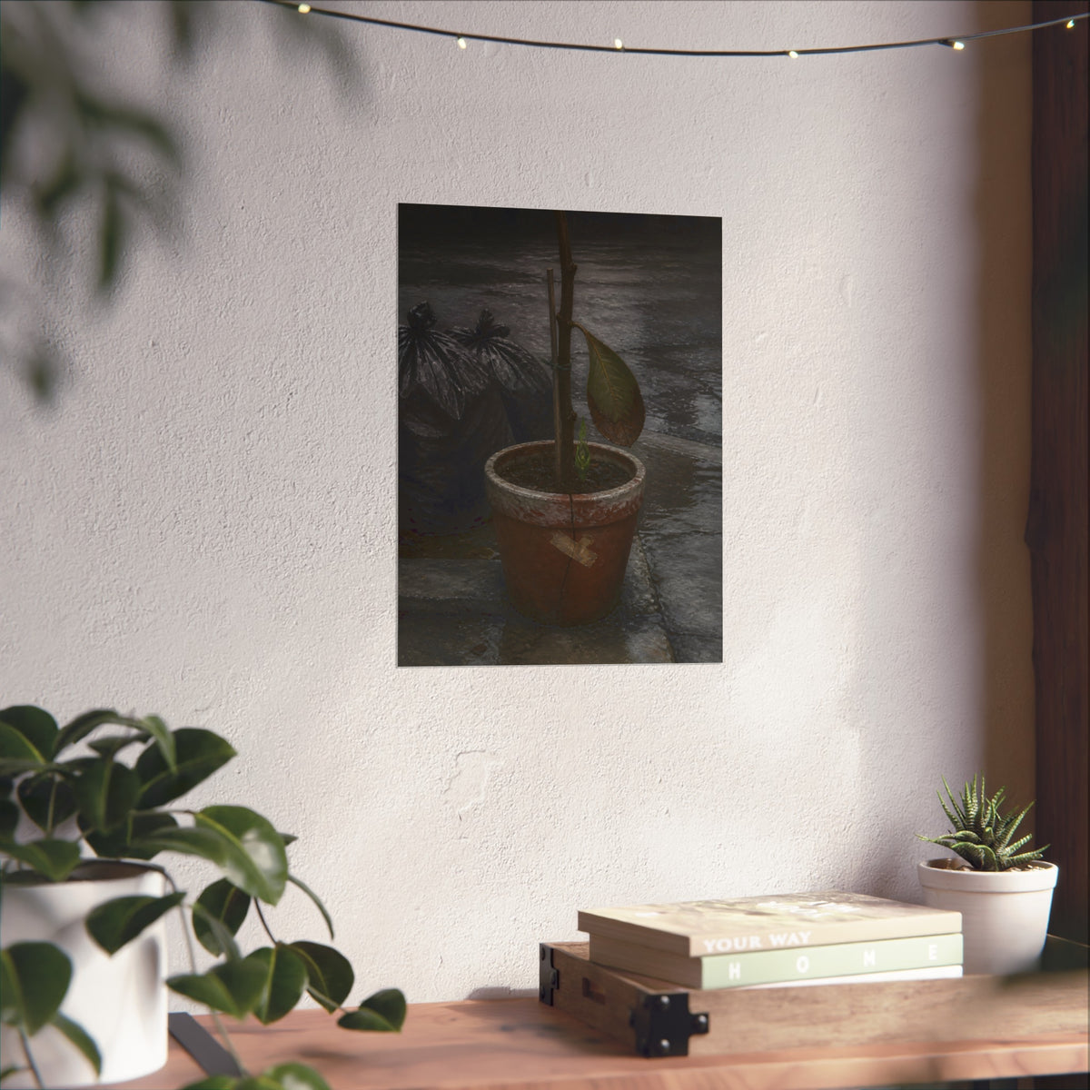 A taped clay pot with one leaf and a green shoot on wet pavement. The Green at the Base by Garabaggio, fine art print hanging in a room.