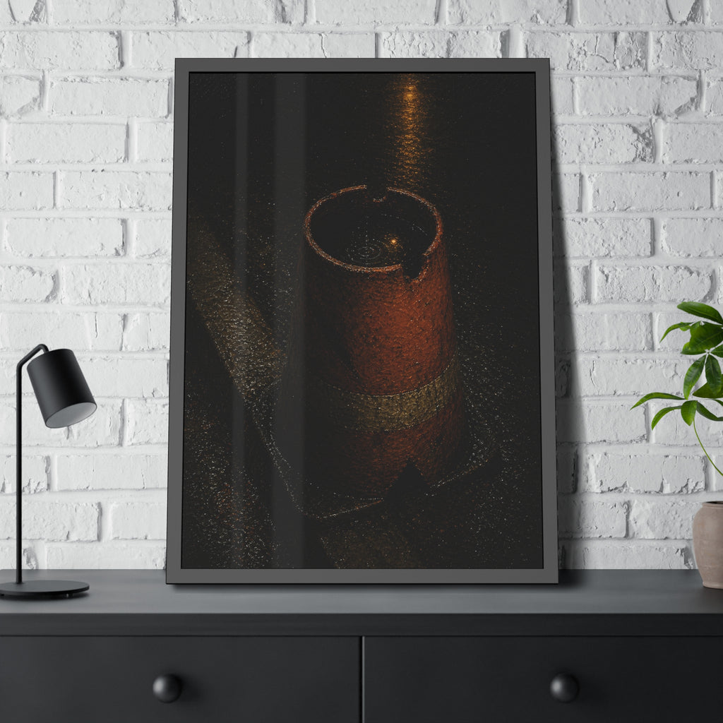 An upturned traffic cone holding rainwater at a wet curb under a lamp. The Cup of Rain by Garabaggio, framed fine art print hanging in a room.