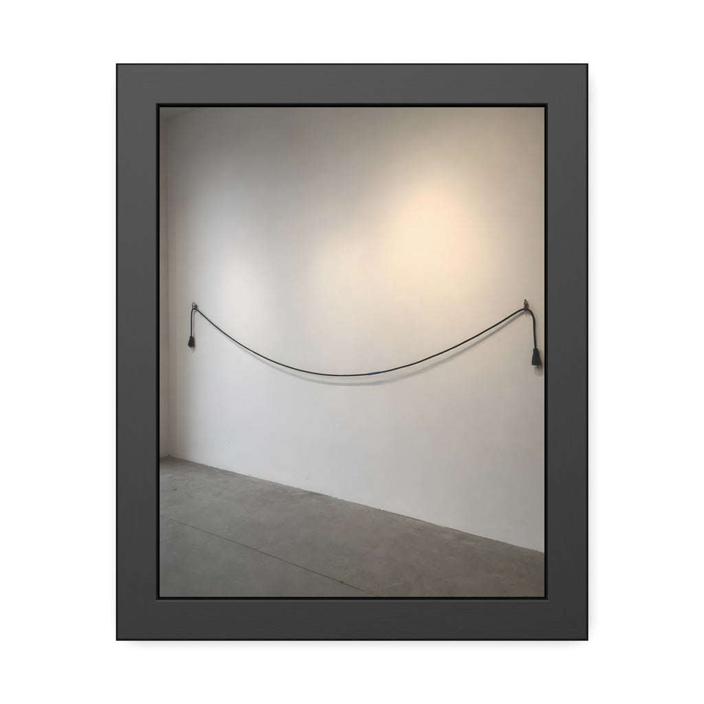 An extension cord hung in a long slack curve across a bare white wall. The Unplugged Line by Garabaggio, framed fine art print, 11″ x 14″.
