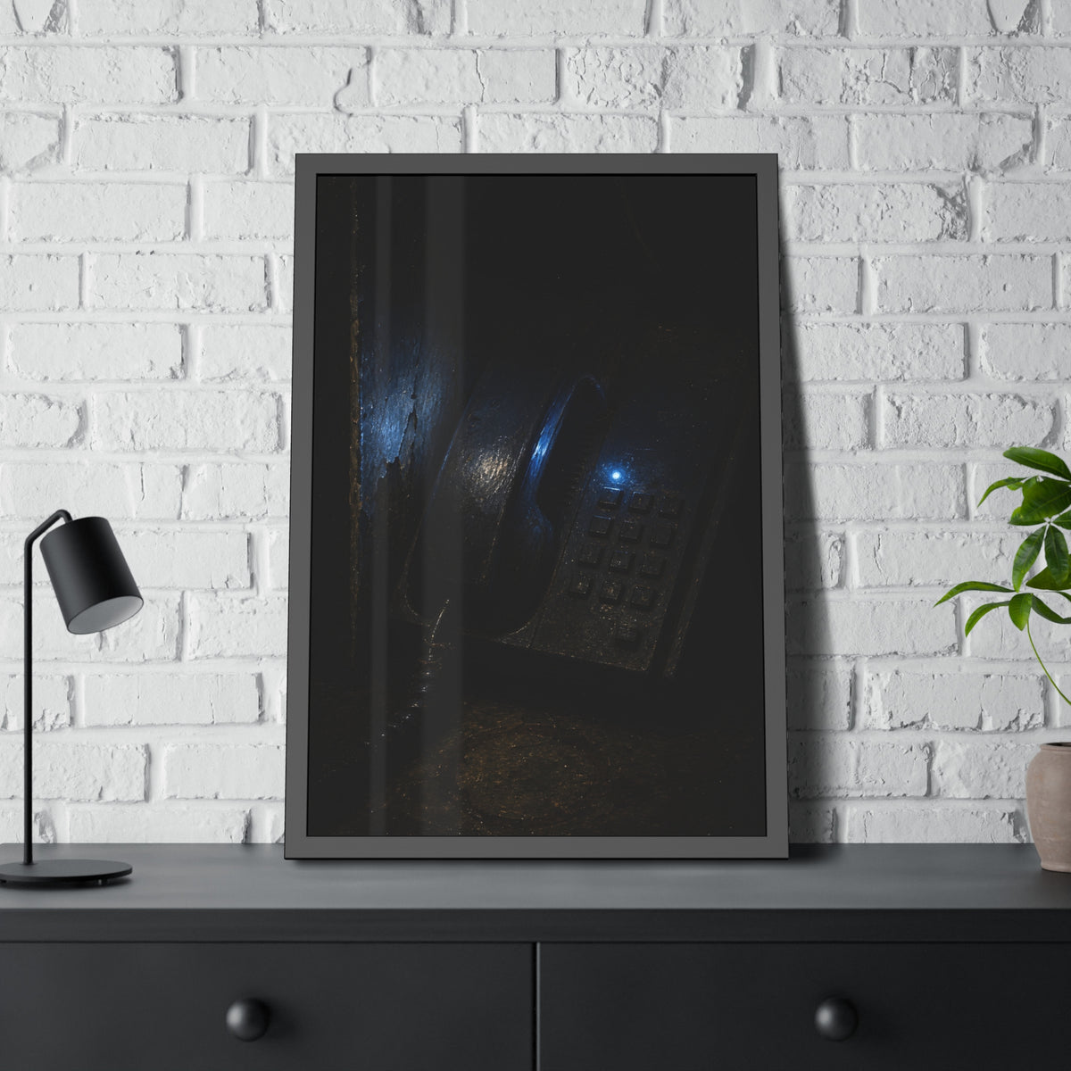 A grimy wall telephone in darkness with one small blue indicator light. The Night Queue by Garabaggio, framed fine art print hanging in a room.