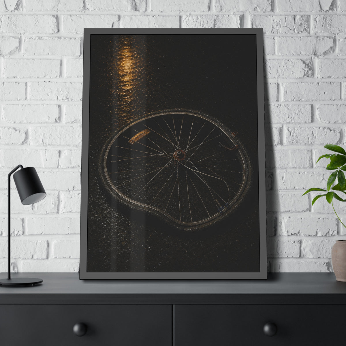 A buckled bicycle wheel on wet asphalt beneath a streetlight reflection. The Bend from Impact by Garabaggio, framed fine art print hanging in a room.