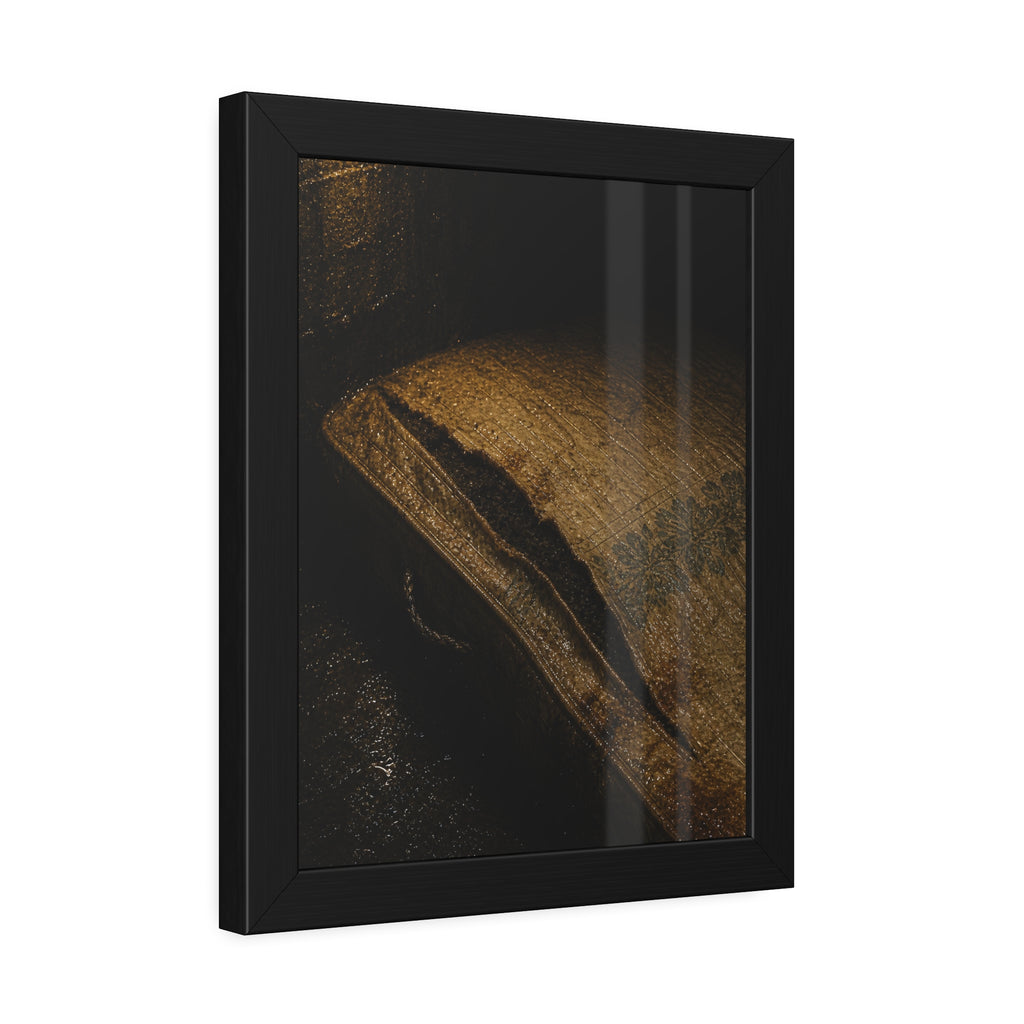 A mattress with its seam split open, lit warm against a dark wall. The Opening of the Ticking by Garabaggio, framed fine art print hanging in a room.