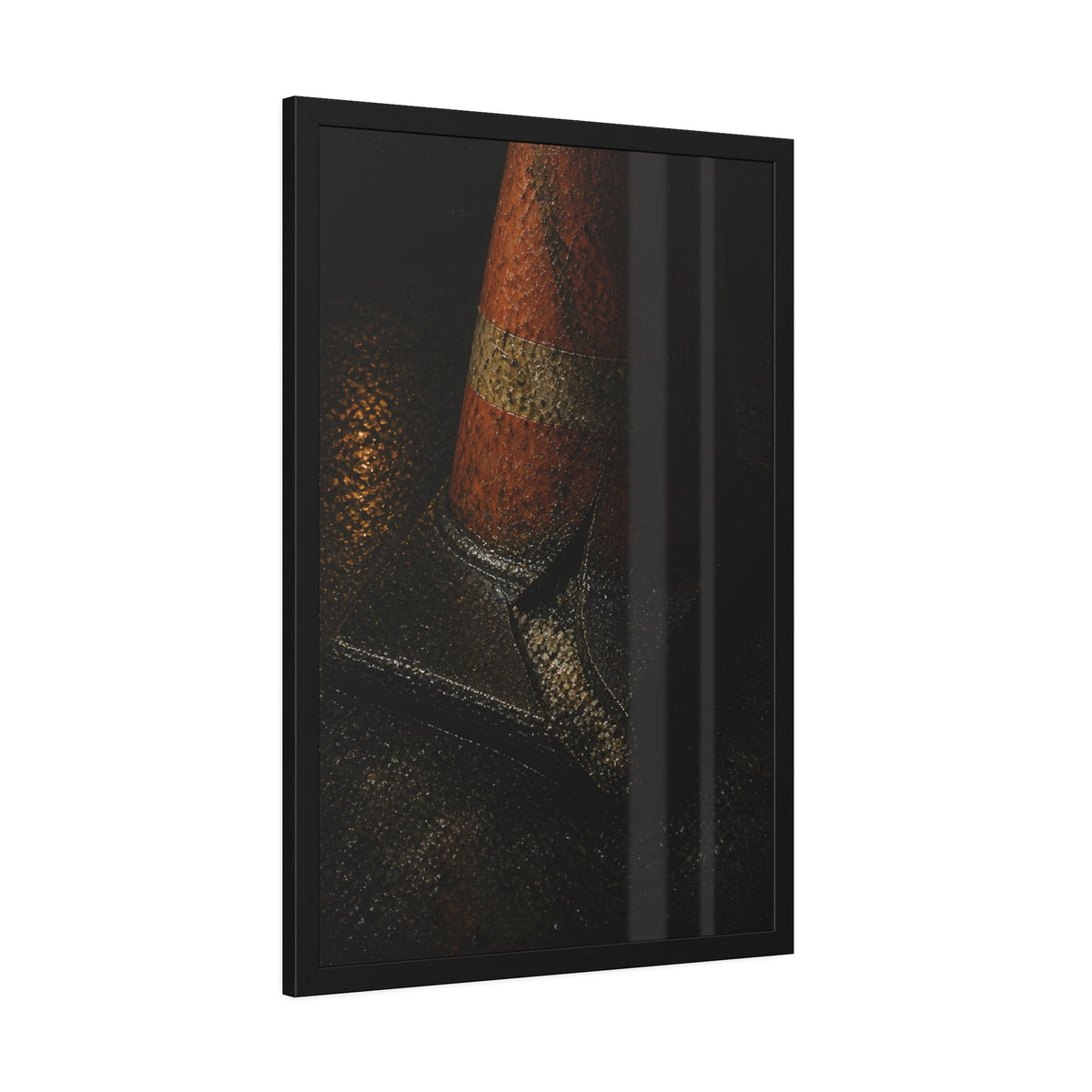 An orange traffic cone with a split base on wet asphalt at night. The Splitting of the Base by Garabaggio, framed fine art print hanging in a room.