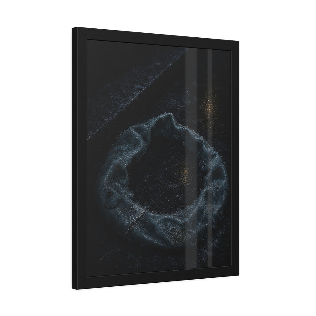 A deflated ring float collapsed on wet pavement under distant amber light. The Freezing of the Smile by Garabaggio, framed fine art print hanging in a room.