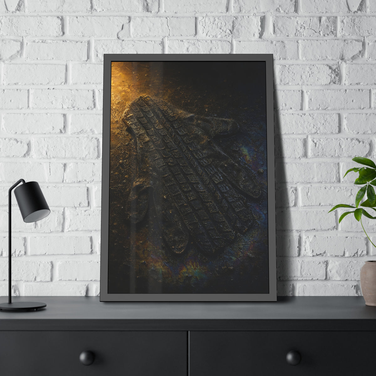 A flattened work glove on asphalt with a tire tread pressed across it. The Passage of the Wheel by Garabaggio, framed fine art print hanging in a room.
