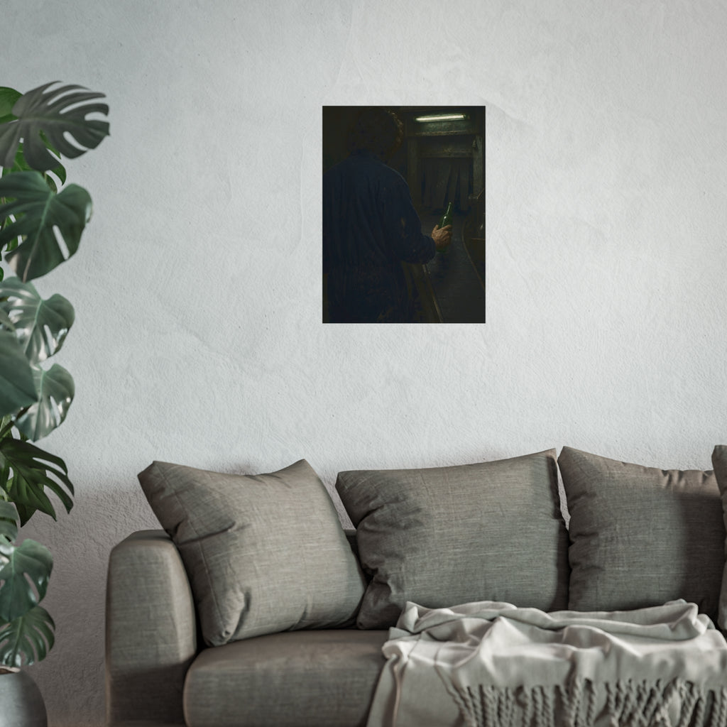 A man in coveralls sets a green bottle on a conveyor under a strip light. Garabaggio at the Conveyor by Garabaggio, fine art print hanging in a room.