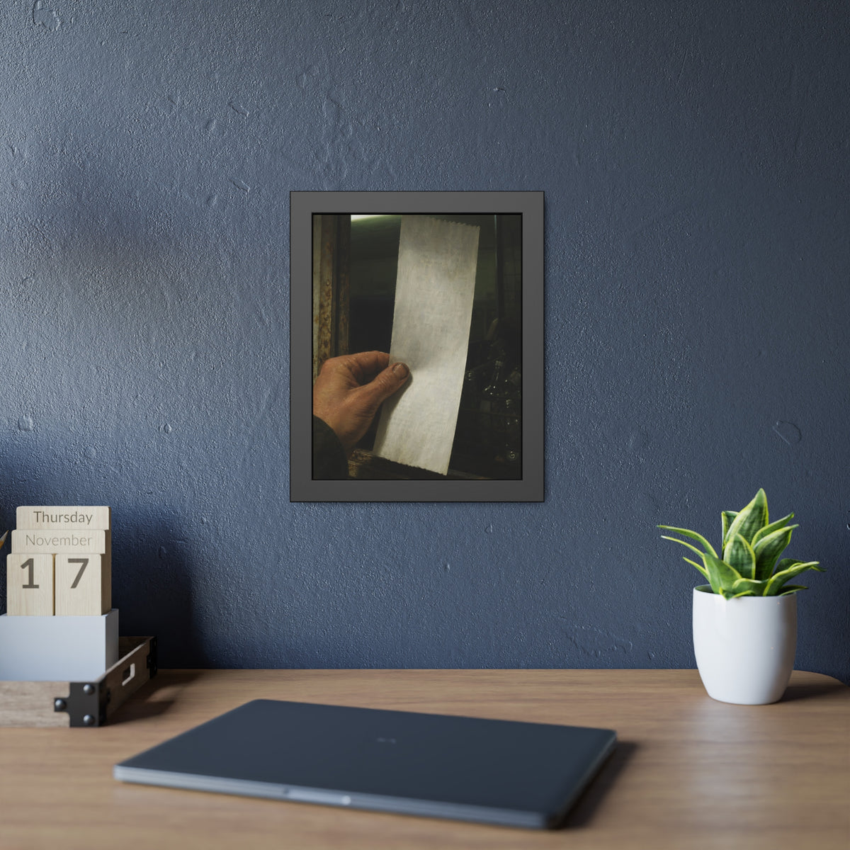 A hand holding a blank slip at a rusted counter window, bottles behind. The Receipt of Absolution by Garabaggio, framed fine art print hanging in a room.