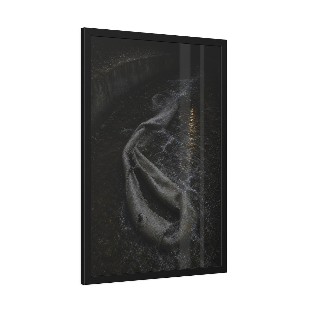 A deflated pool float caught in a concrete drainage channel of running water. The Release into Runoff by Garabaggio, framed fine art print hanging in a room.