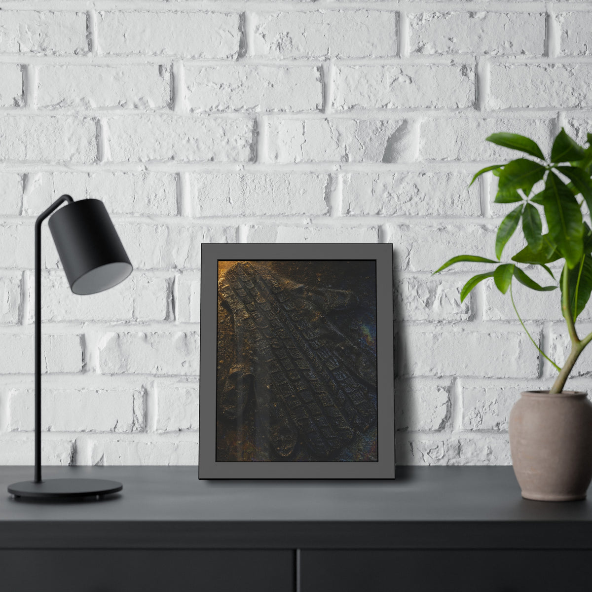 A flattened work glove on asphalt with a tire tread pressed across it. The Passage of the Wheel by Garabaggio, framed fine art print hanging in a room.