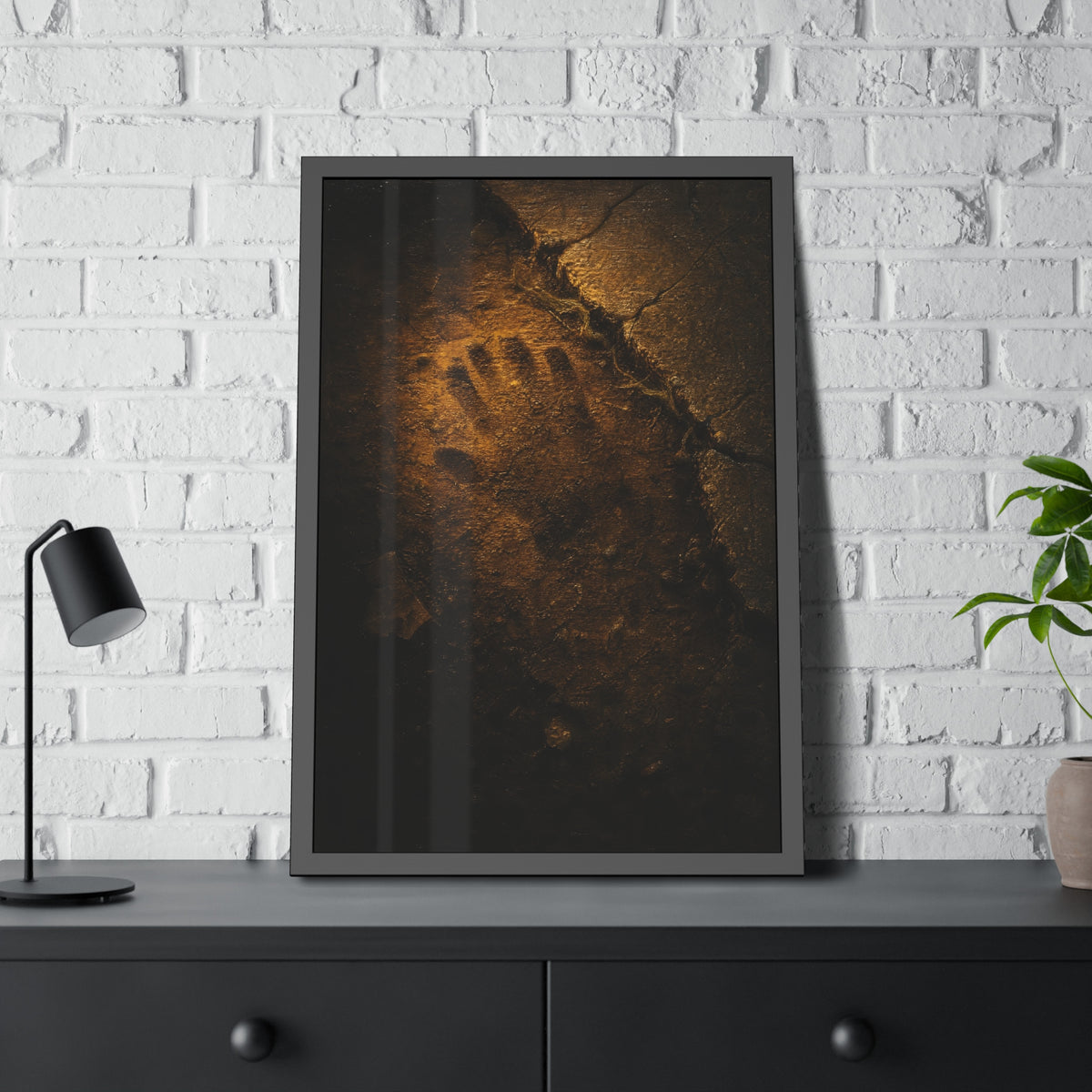 A glove shaped imprint left in cracked asphalt under warm light. The Assumption, or: What Remains by Garabaggio, framed fine art print hanging in a room.