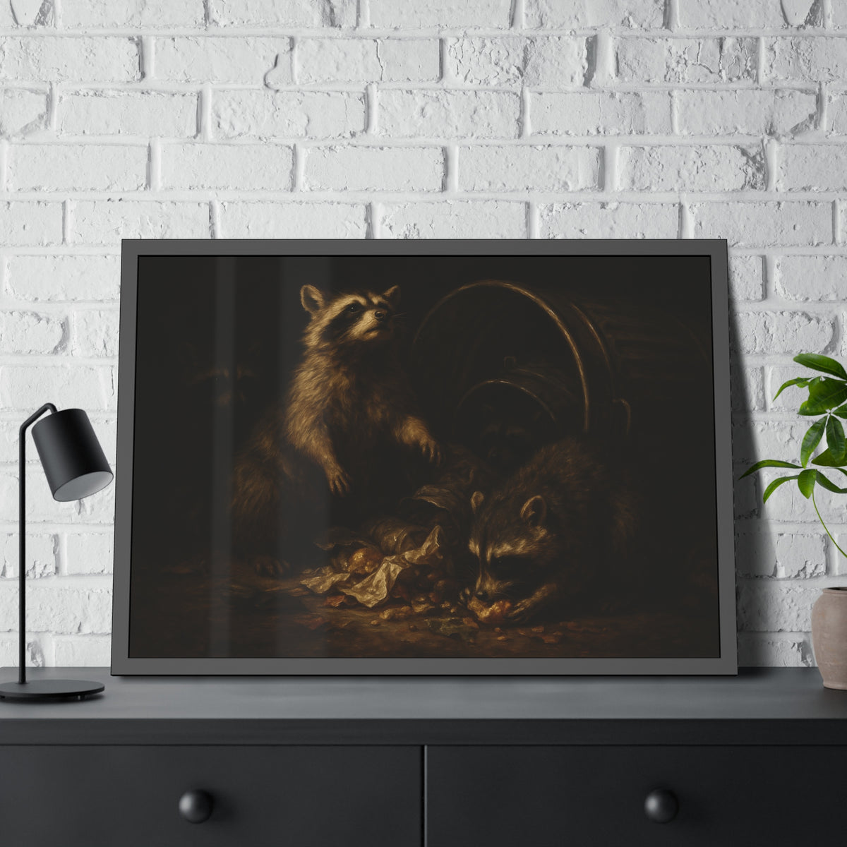 Raccoons feeding on scraps around a tipped metal trash can in the dark. The Calling of St. Trash by Garabaggio, framed fine art print hanging in a room.