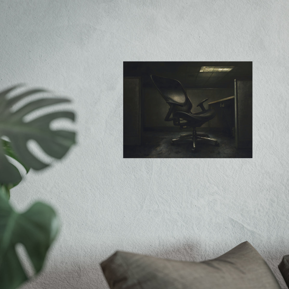 An office chair tilted back in an empty cubicle under one ceiling light. The Ergonomic Chair, Unlocked by Garabaggio, fine art print hanging in a room.
