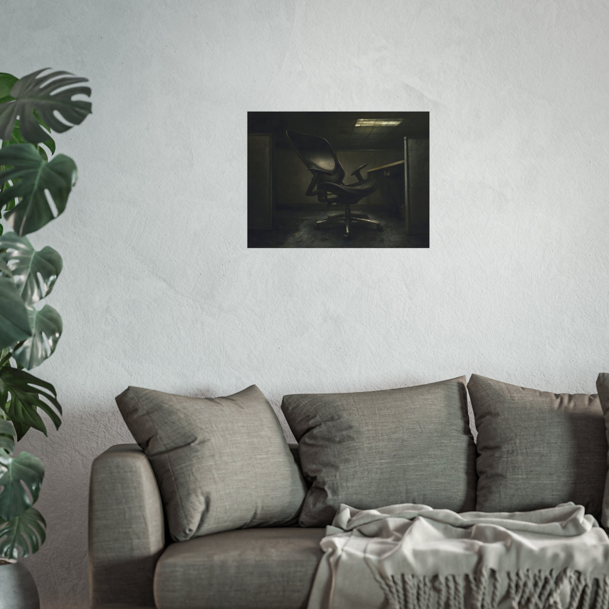 An office chair tilted back in an empty cubicle under one ceiling light. The Ergonomic Chair, Unlocked by Garabaggio, fine art print hanging in a room.