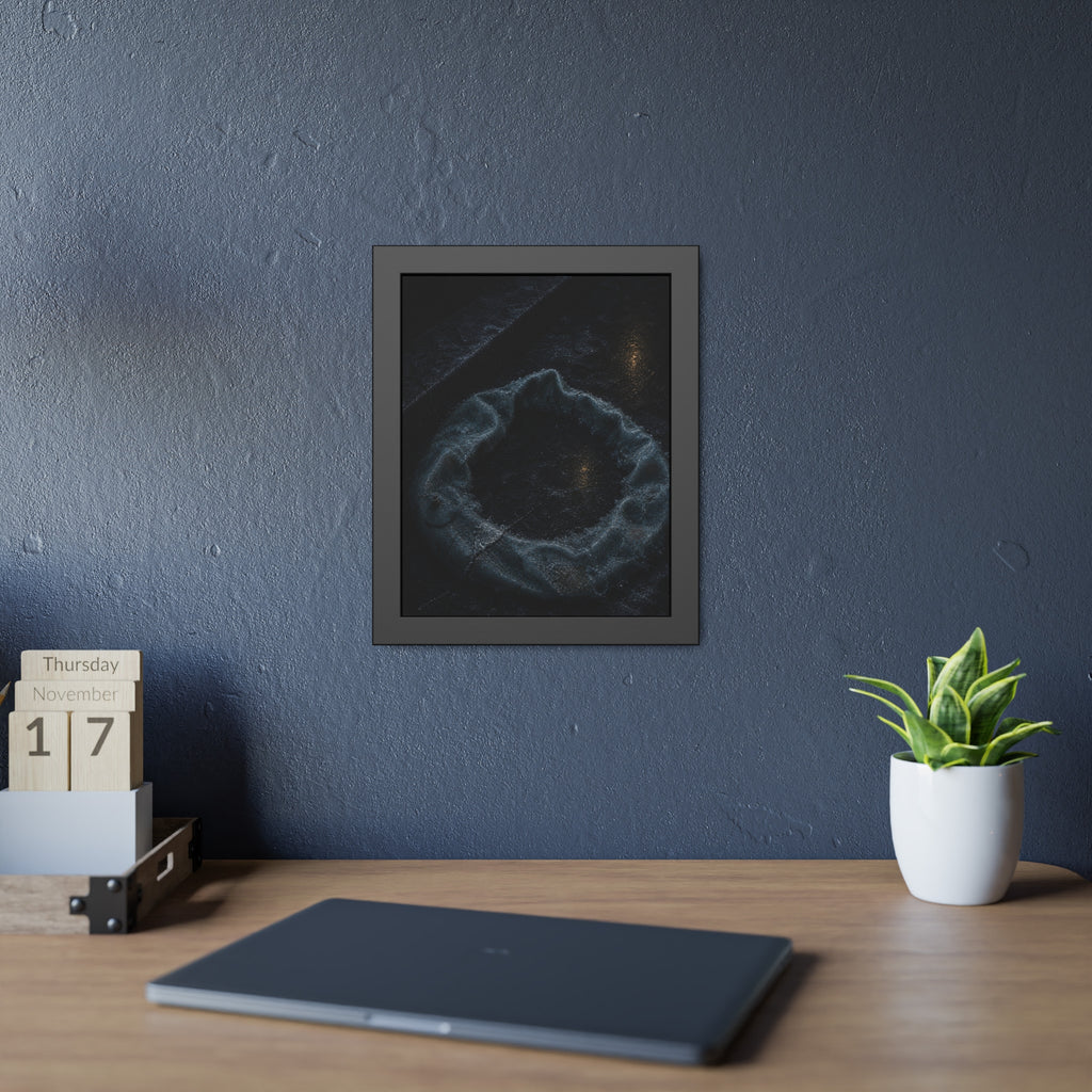 A deflated ring float collapsed on wet pavement under distant amber light. The Freezing of the Smile by Garabaggio, framed fine art print hanging in a room.